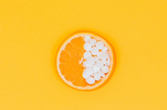half of an orange with medicine, to represent food supplements